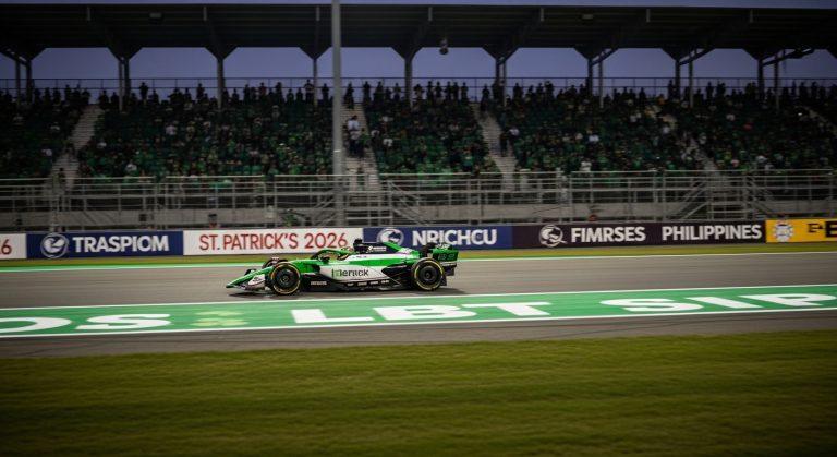 Race car on track with St Patrick's Day styling and Philippine fans.